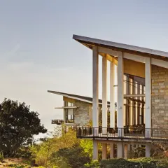 The Club Mahindra Tungi Resort, a lakeside retreat designed to be shaped by its landscape. The structure sits quietly overlooking Pawna Lake, with angled roofs and expansive windows that draw the scenery inward, creating a seamless connection between the built form and the natural terrain.