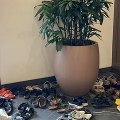 A pile of shoes outside the workshop door. This simple image represents a community of people coming together, leaving the outside world behind to share a space of learning and practice.