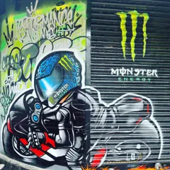 A detailed shot of the biker graffiti we created for the Monster Energy mural. The design captures the speed and energy of motorcycle racing, perfectly aligning with the store's identity.
