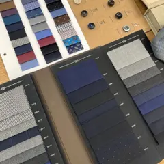 Our at-home consultation includes exploring a vast library of fabric books. Here you can see options for suitings, linings, and buttons all in one place.