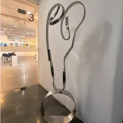 With just a few elegant lines of polished steel, "The Bond" captures the powerful and unconditional love between a mother and child. This freestanding figurative sculpture is an exploration of pure emotion rendered in a strong, resilient material.