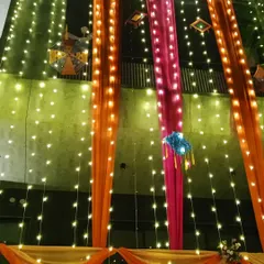A closer look at the night decoration, showing how the warm fairy lights illuminate the colorful drapes and traditional hangings on the balconies.
