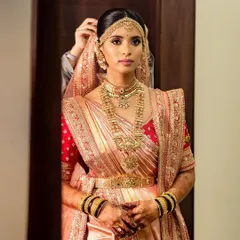 This bride is the epitome of royalty in her stunning silk saree and gold jewelry. Her simple yet elegant mehendi design adds a touch of grace to her regal look.