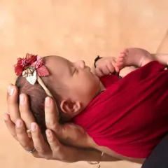 So small, held so securely in loving hands. This close-up shot is a powerful representation of how tiny and precious a newborn is.