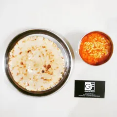 A popular and comforting meal of Sev Tameta nu Shaak served with a crispy Kathiyawadi Bhakhri. The tangy tomato curry with crunchy sev is a true Gujarati favorite.