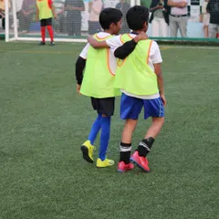 An arm around a teammate's shoulder shows the bond that forms when playing together as part of the Sportonix FC family.