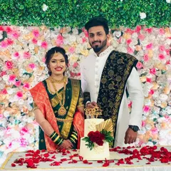 It brings me so much joy to see my clients happy. Here's a lovely couple posing with their two-tiered engagement cake, which features red roses and a modern gold palm leaf accent.