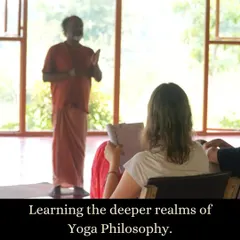 A student listens intently during a yoga philosophy lecture. Our courses delve into the deeper realms of yogic texts and concepts, providing a rich context that goes far beyond the physical asanas.