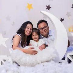 A sweet family portrait on our popular moon and stars set. The soft clouds and twinkling stars create a perfect backdrop for capturing magical family moments.