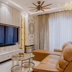 This living and entertainment area is designed for comfort and style. The plush leather recliner is perfect for movie nights, while the custom TV unit includes a dedicated pooja space, seamlessly integrating tradition with modern design.
