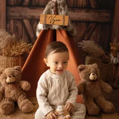 A rustic, woodland-themed shoot for a first birthday. This little boy looks right at home with his teddy bear friends and a personalized teepee.