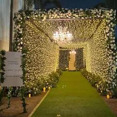 The full view of the starry entrance tunnel, framed with white florals and leading into the garden. This is how we make a grand statement and a memorable first impression.