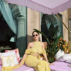 Alaya F radiates in a sunshine-hued embellished sharara. The daring halter neckline and floor-sweeping sleeves blend tradition with fearless, modern fashion.