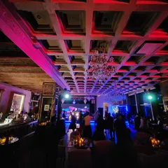 A wide shot of a club event, showing the impressive architecture and lighting that contribute to the overall atmosphere. My music fills the space and brings it to life.