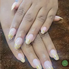 I love how these gold foil flakes look scattered over a natural nude base. This set features long, coffin-shaped nails, giving a modern and luxurious feel that I can create for you right at your home.
