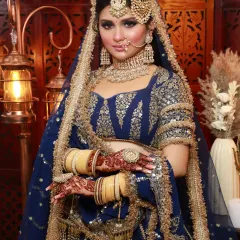 A regal look in a royal blue lehenga. The makeup is bold and defined, with a focus on the eyes, creating a look fit for a queen.