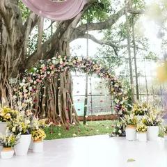 I love using nature as my canvas. For this Haldi, we built a dreamy floral arch right under a magnificent banyan tree, letting the decor feel like a natural extension of the beautiful surroundings.