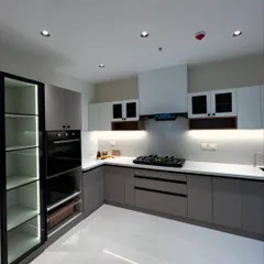 A great kitchen is the heart of the home. We designed this modern kitchen with a focus on clean lines, functionality, and layered lighting. It features two-tone handleless cabinets, a built-in oven, and an illuminated glass pantry for a sleek, organized look.
