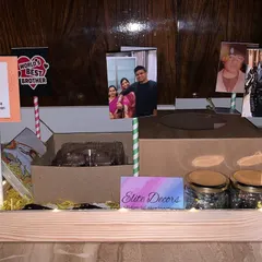 I can incorporate your personal photos to make the gift extra special. This Rakhi hamper for a brother includes multiple photo stands alongside jars of treats and other goodies in a personalized tray.
