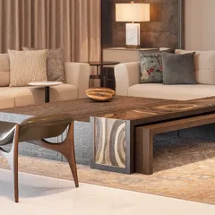 The intricately carved metal top of the center table is a nod to the client's request for Indian elements within a contemporary framework. This piece, like all our furniture, was crafted in our own workshop.