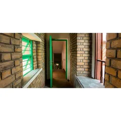 A hallway at the Butterflies Centre, showcasing the texture and warmth of the earth block walls. This material is not only sustainable but also provides excellent thermal insulation, keeping the interiors comfortable.