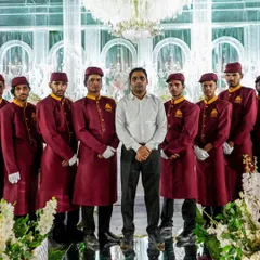 Here I am with my dedicated service team, standing before a beautifully decorated wedding stage. We work together seamlessly to ensure every detail of your event is perfect.