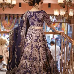 Feel like royalty in this deep purple Banarasi lehenga. The rich silk is woven with golden peacock motifs, giving it a classic and regal feel that’s perfect for your special day.