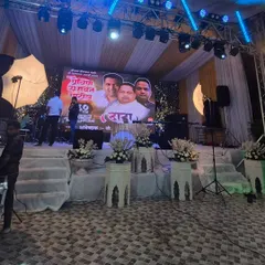 A clear view of the stage front, showing the clean white platforms and floral arrangements that complement the high-tech elements. This demonstrates how I balance classic decor with modern event technology.