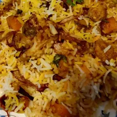 A close-up of my Veg Dum Biryani. I use fresh vegetables, fragrant basmati rice, and fried onions to create layers of flavor, cooked in the traditional Hyderabadi dum style.