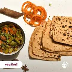A simple, wholesome, and delicious vegetarian thali. Here you see a seasonal veg sabzi with parathas and a side of spiced onions. It's the kind of everyday food that you'll never get tired of.