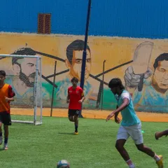 A player controls the ball before taking a shot, demonstrating the close control we teach in our dribbling and shooting sessions.