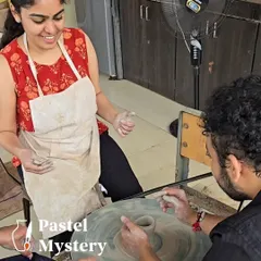 Our instructors are always on hand to help. Here, we are guiding a guest through the initial steps of shaping his pot, ensuring a fun and stress-free learning environment for everyone.