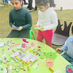 Kids of different ages working together at a craft table. I foster a collaborative environment where children can learn from each other while having fun.