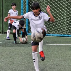 Skill and focus in action. We guide our U12 players to master advanced techniques like ball control and juggling. Each training session is a step towards realizing their potential and building a bright future in the sport.