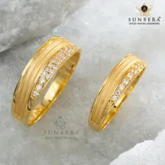 A classic design for the modern couple. These matching gold bands feature a grooved texture complemented by a sparkling row of diamonds, blending traditional craftsmanship with contemporary style.
