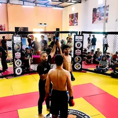 The moment of victory. A referee raises the arm of our fighter after a tough bout in the cage at the Delhi State MMA Championship. This is the result of countless hours of training and dedication.