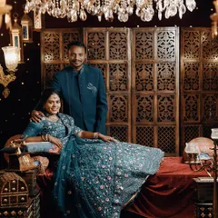 A wide shot of a couple on a luxurious, royal-themed set, perfect for a grand and opulent pre-wedding album.