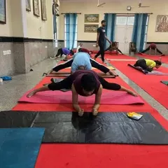 This image from a group class shows students working on a deep hip-opening stretch. We focus on building flexibility through consistent and safe practice.