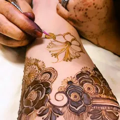 A moment from a birthday henna session, showing the creation of a delicate flower. I use only pure, organic henna for all my clients.
