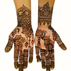 A classic and elegant henna design featuring a beautiful peacock on one palm and a vase of flowers on the other. The wrists are adorned with intricate cuff patterns, perfect for any festive occasion.