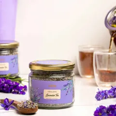 A bright and clean product shot for lavender tea. The light background and fresh lavender sprigs create an airy, calming mood, perfectly suited for a wellness or herbal tea brand.