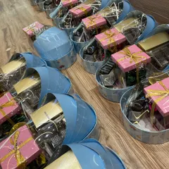 A row of my signature blue cradle-shaped gift baskets, all packed and ready to be sent out for a baby boy announcement.