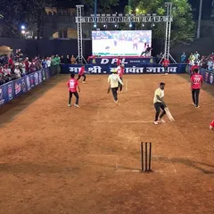 A wide-angle view of a match in progress at the DPL tournament. The large LED screen in the background shows live action, while the entire ground is evenly lit for perfect visibility.