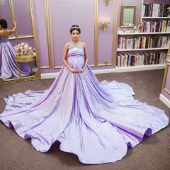 Feel like absolute royalty in our lilac iridescent ballgown. The magnificent trail spreads out to create a fairytale scene, making you the queen of your own story. This gown is perfect for an opulent indoor pregnancy photoshoot.