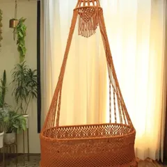 Our macrame baby swing in a warm terracotta color. You can choose any color and design, and we'll make it for you at a price that fits your budget.