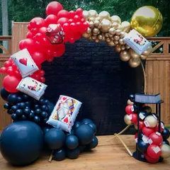 A modern take on a casino theme, with a circular balloon arch in red, black, and gold. I incorporated dice and playing card pillows into the balloon design for a fun, thematic touch.