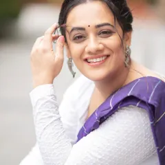 A happy, close-up shot showcasing the simple yet elegant makeup and jewelry I chose to complement Spruha Varad's purple saree.