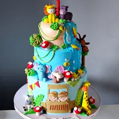 A bright and beautiful jungle safari cake for a twins' first birthday. This three-tiered masterpiece is packed with handcrafted animals, a waterfall, and two little explorers in a jeep.