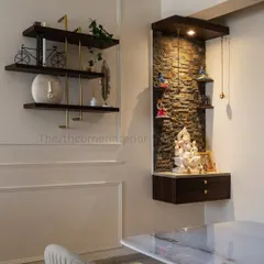 A closer look at the pooja unit, highlighting the spotlight that illuminates the beautiful stone texture and the white marble Ganesha statue, enhancing the sacred atmosphere of the space.
