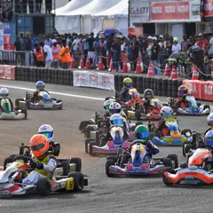 A full grid of karts streams through a corner at the CoASTT circuit. Our events attract large, competitive fields, making for spectacular racing.